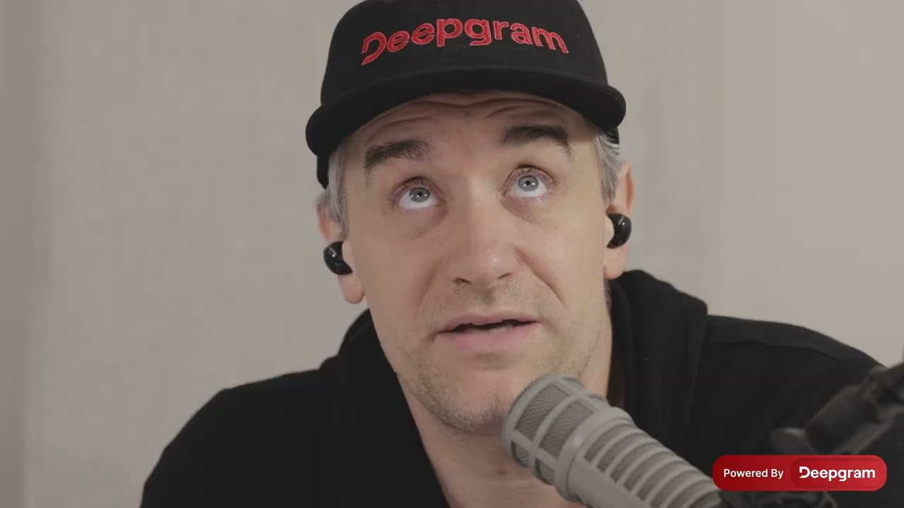 Still from a founder video recorded at a podcast microphone